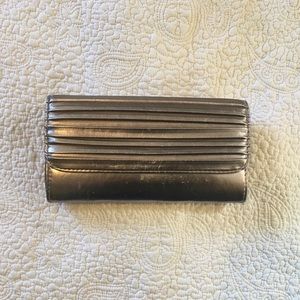 Silver button up clutch free with purchase